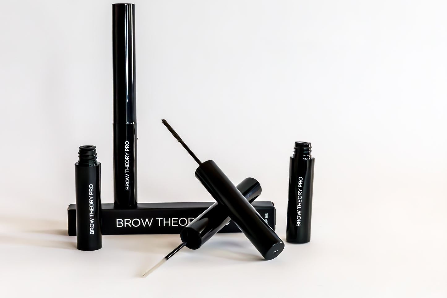 Black eyebrow grooming product set on a white background