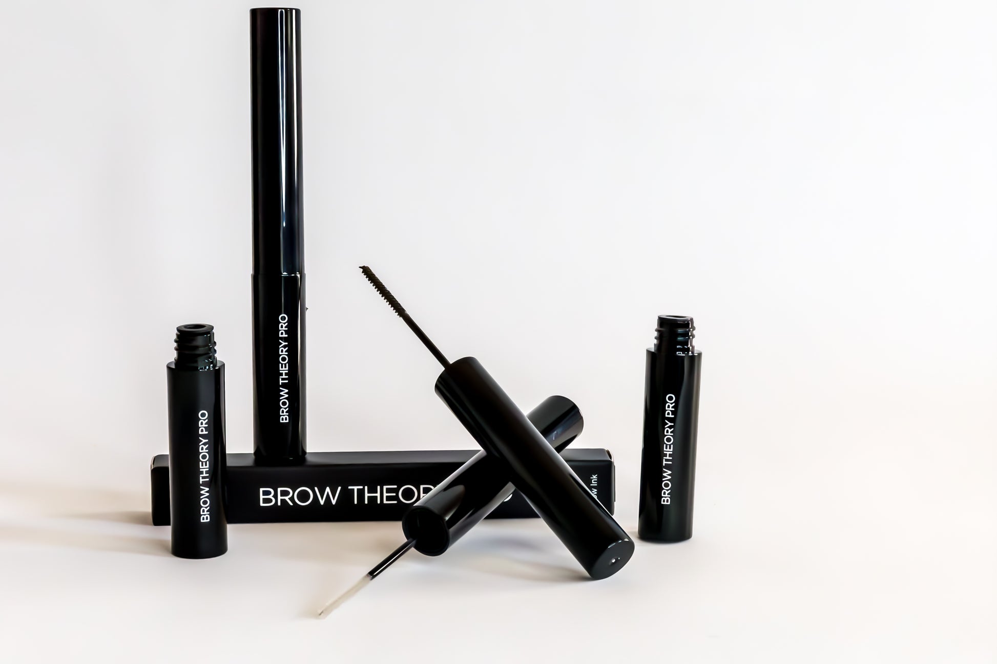 Black eyebrow grooming product set on a white background