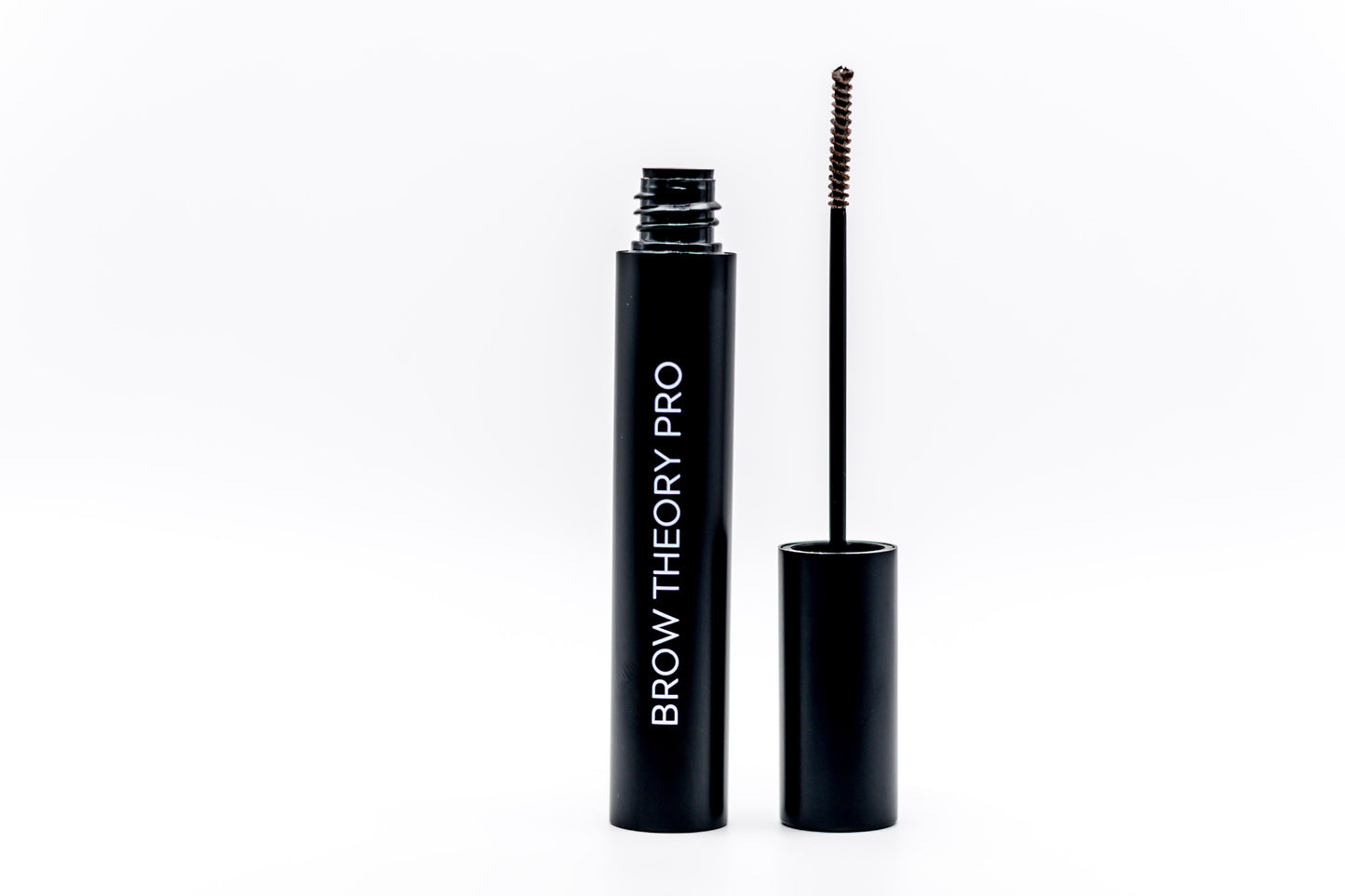 Brow Theory Pro brow gel shown with the open black tube and the spoolie wand applicator on a clean white background.