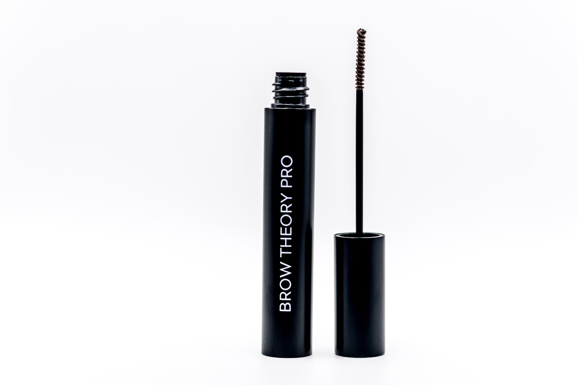 Brow Theory Pro brow gel shown with the open black tube and the spoolie wand applicator on a clean white background.